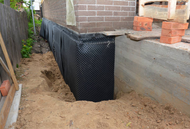 SJ Waterproofing Pros technician performing targeted Waterproofing assessment in Butlerville, IN